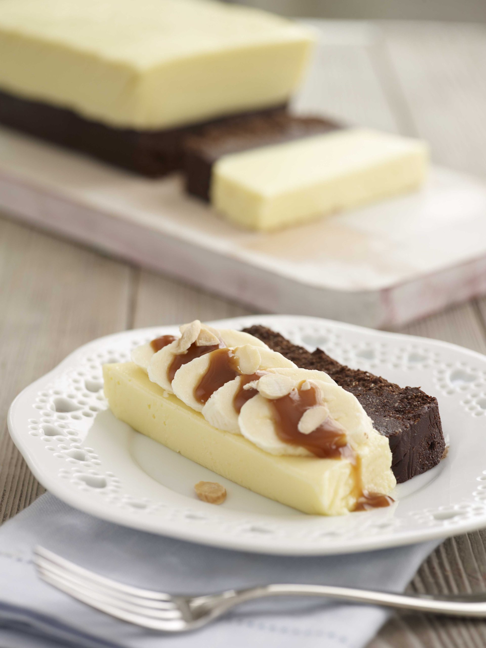 White Chocolate and Praline Mousse with Sliced Bananas and Butterscotch Sauce -