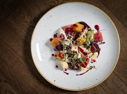 Roasted beetroot and Cornish Yarg salad with mustard leaves, moutabel and pomegranate oil -