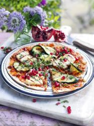 Flatbread pizza topped with harissa, shredded lamb, pomegranate, mint and char-grilled halloumi -